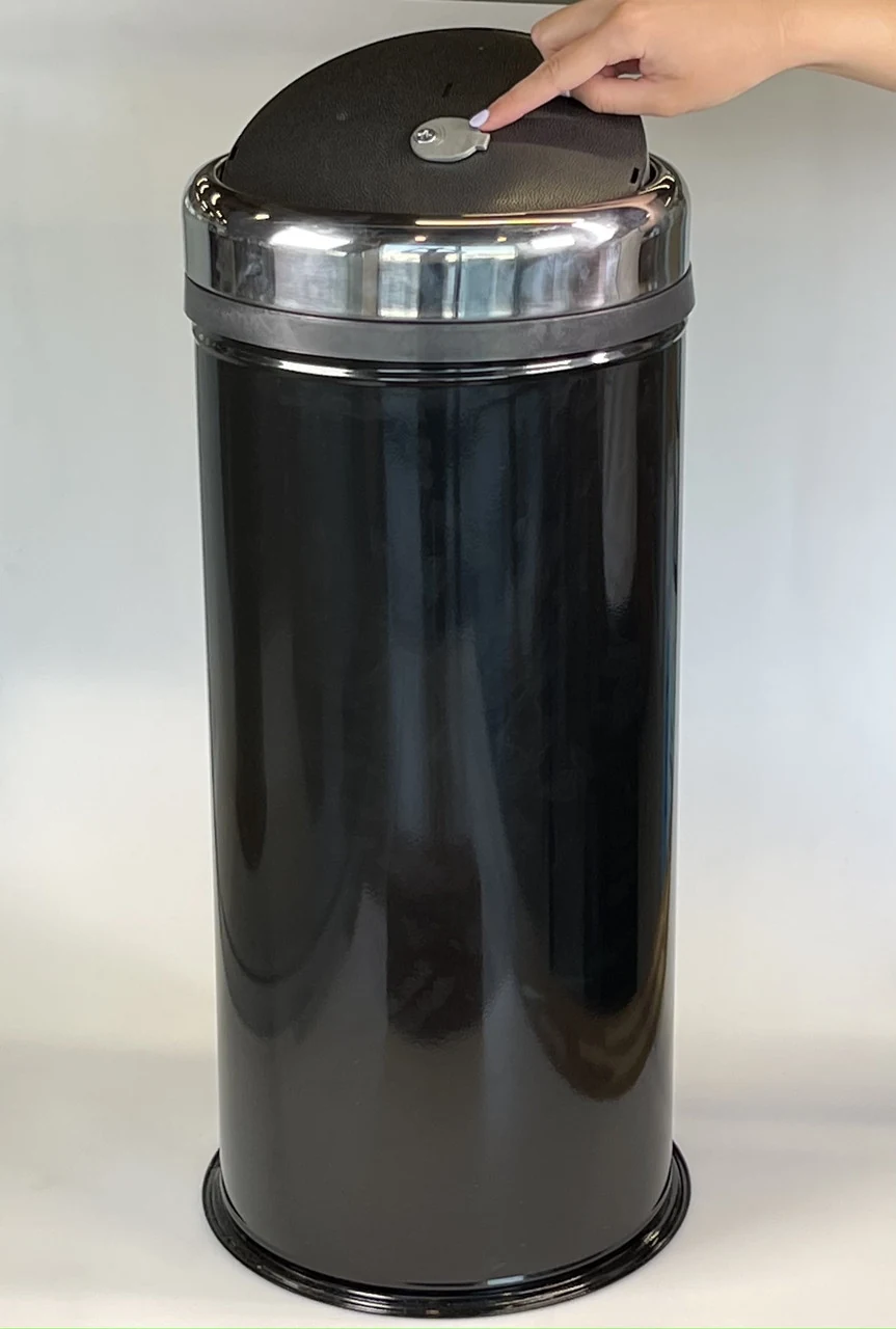 Round trash can with rotating stainless steel lid and rim 27 liters black